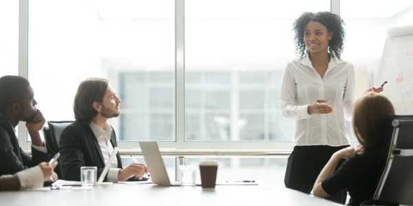 A marketing manager going over strategies with her marketing team.