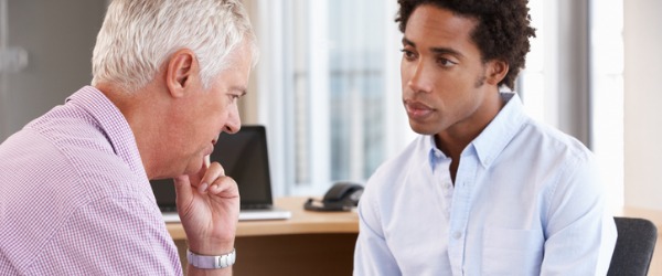 A clinical psychologist listening to a client.